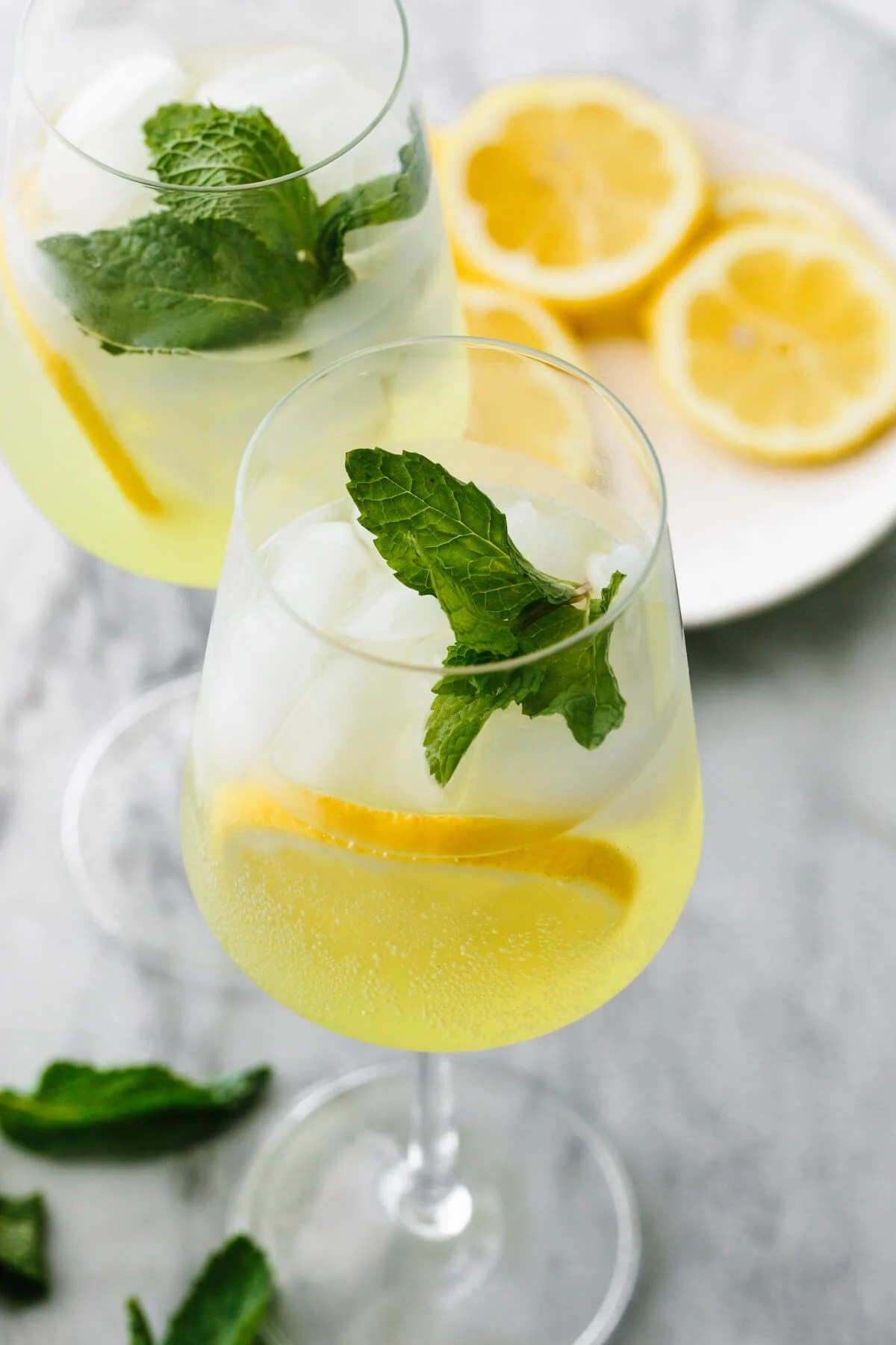 Glasses of limoncello spritz with mint leaves