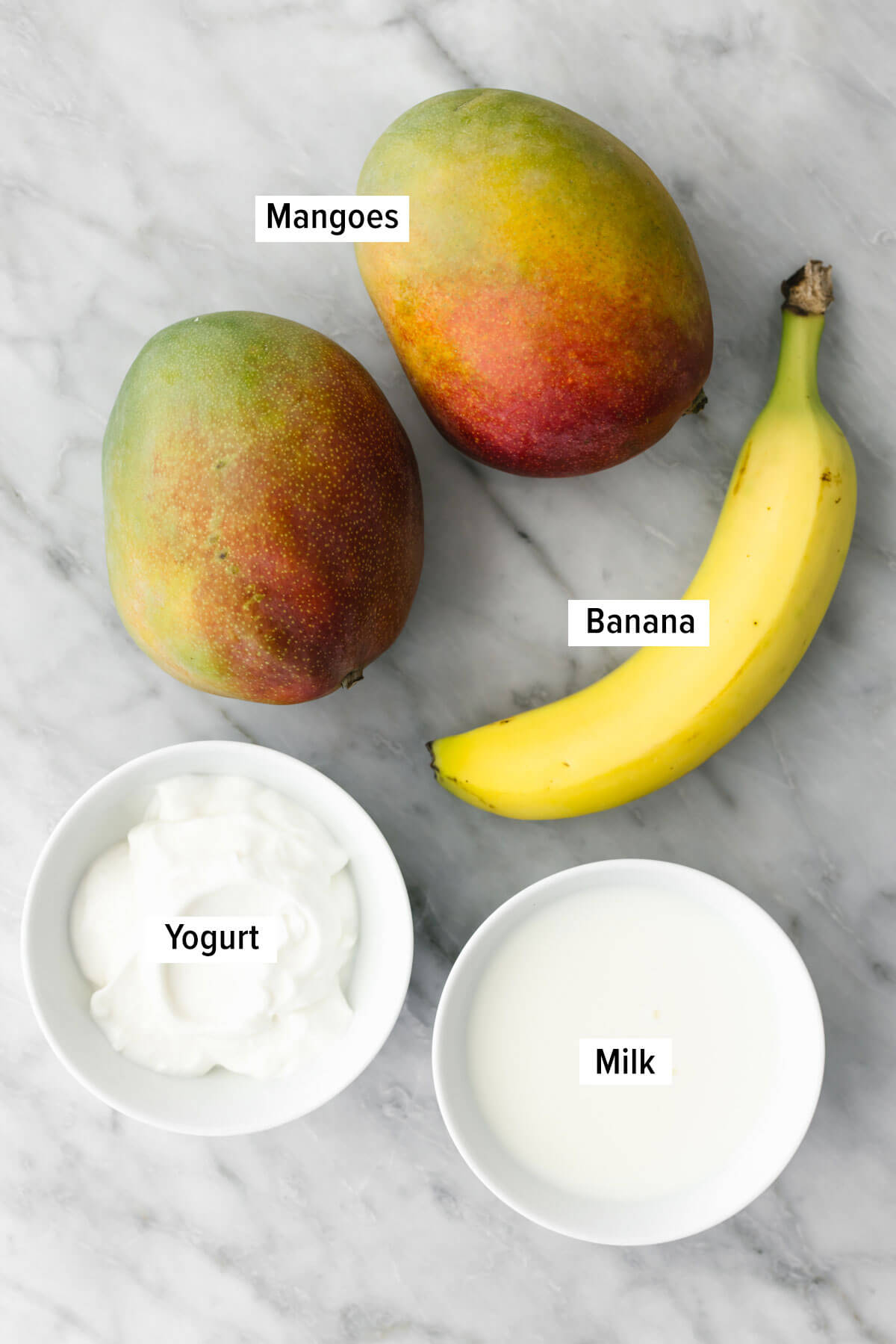 Ingredients for mango smoothie on a table.