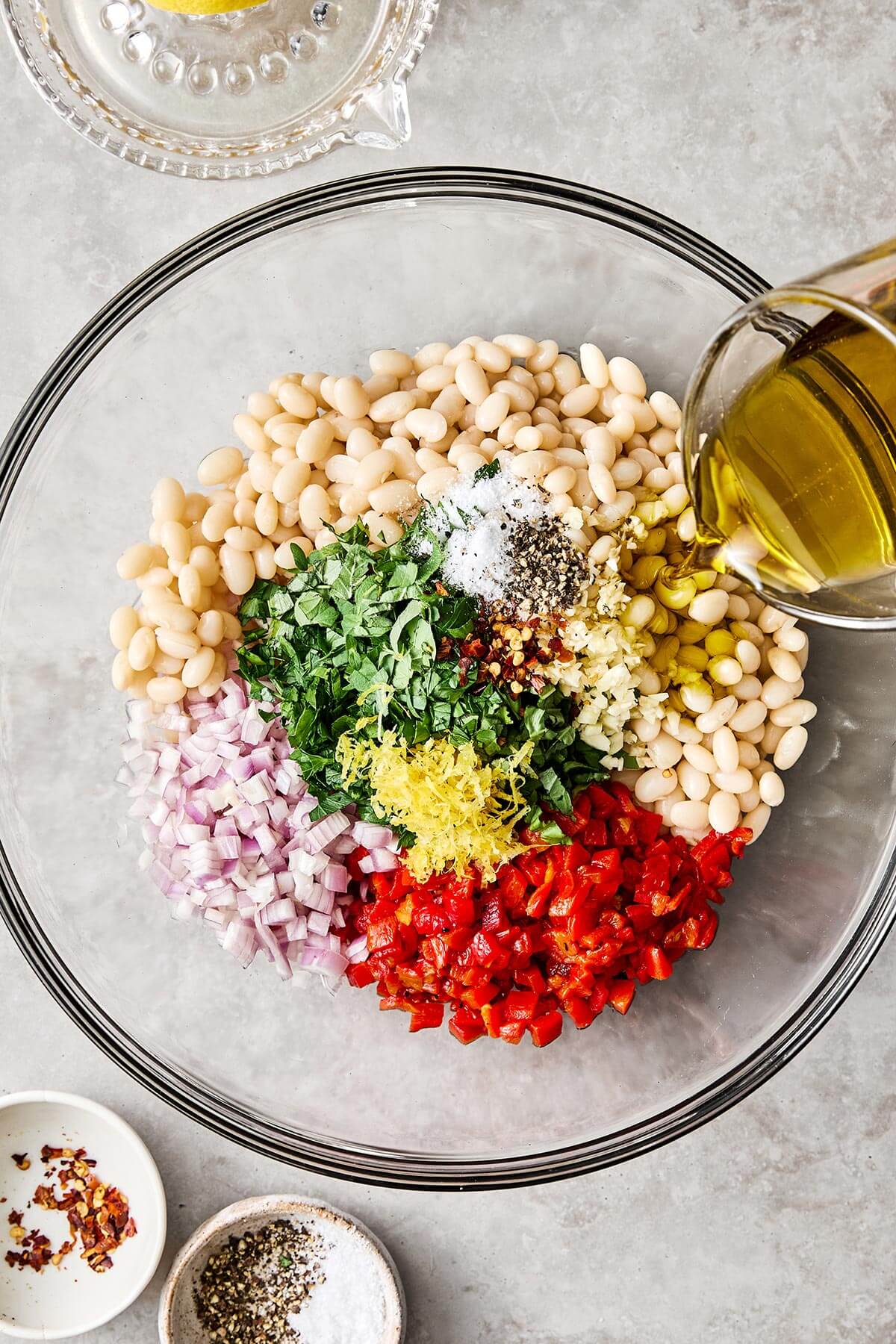 Marinated white bean ingredients in a bowl.