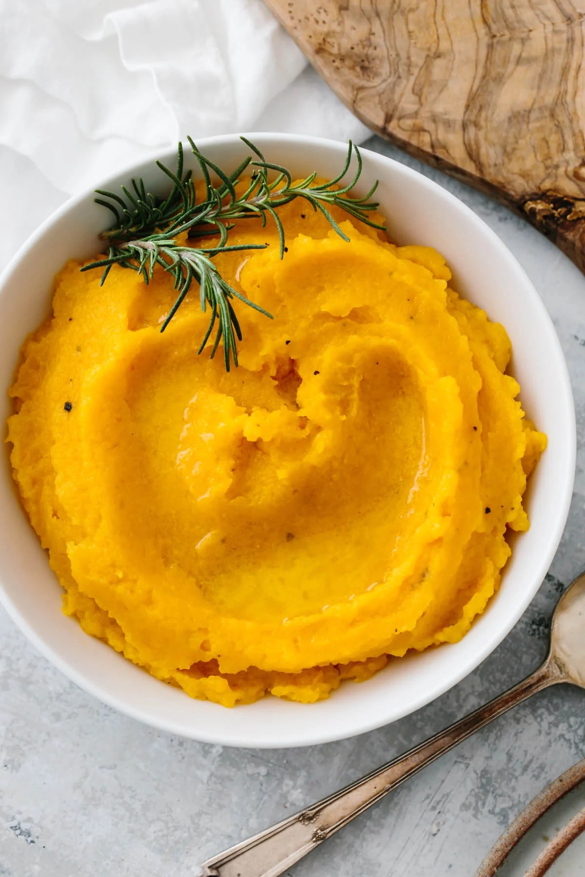 Mashed butternut squash in a white bowl.