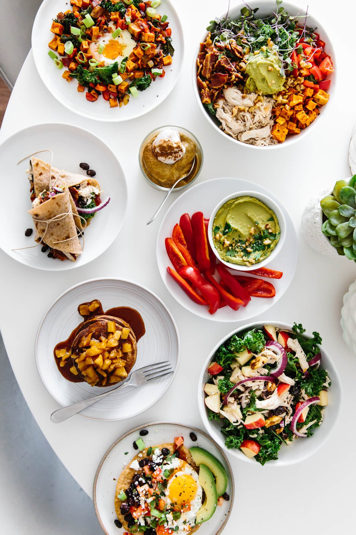 Several plates of meal prepped food on a table.