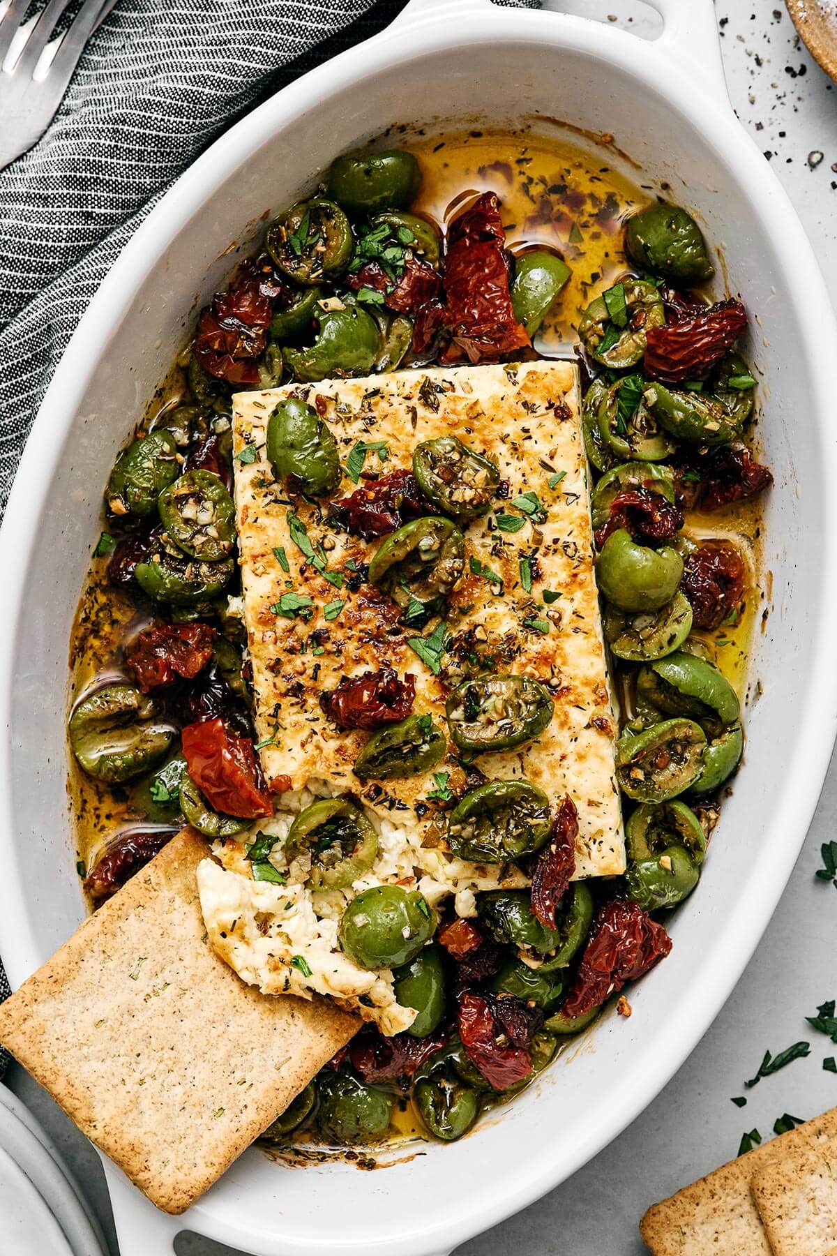 Mediterranean baked feta with a cracker.