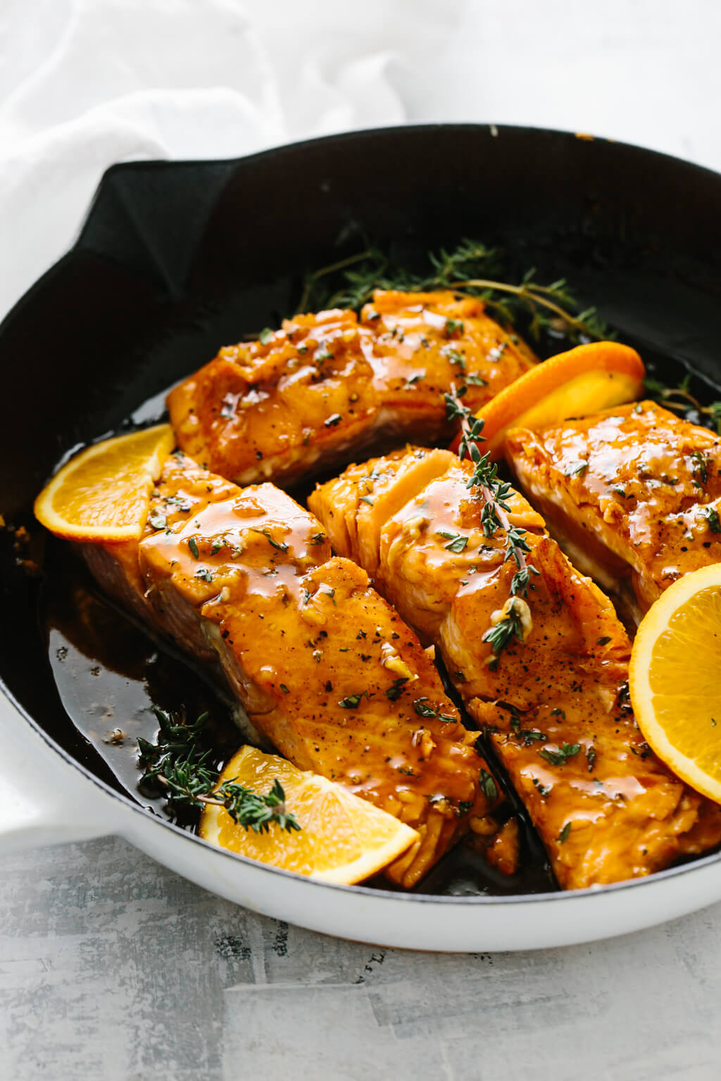 Orange glazed salmon in a pan.