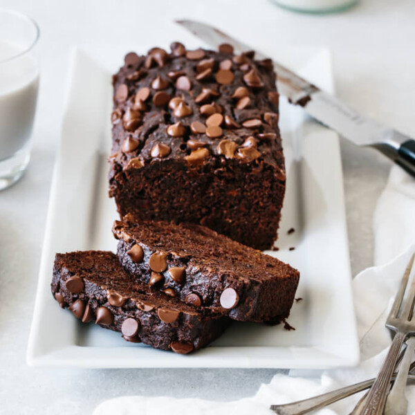 paleo chocolate zucchini bread on a white serving platter.