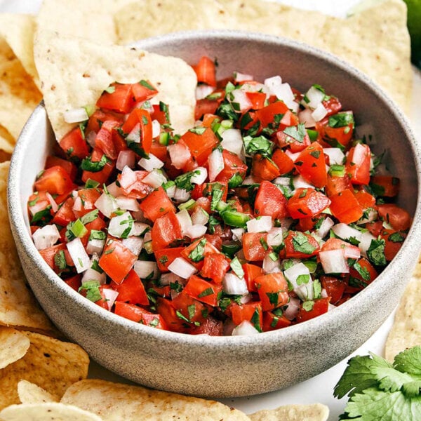 A bowl of pico de gallo and chips.