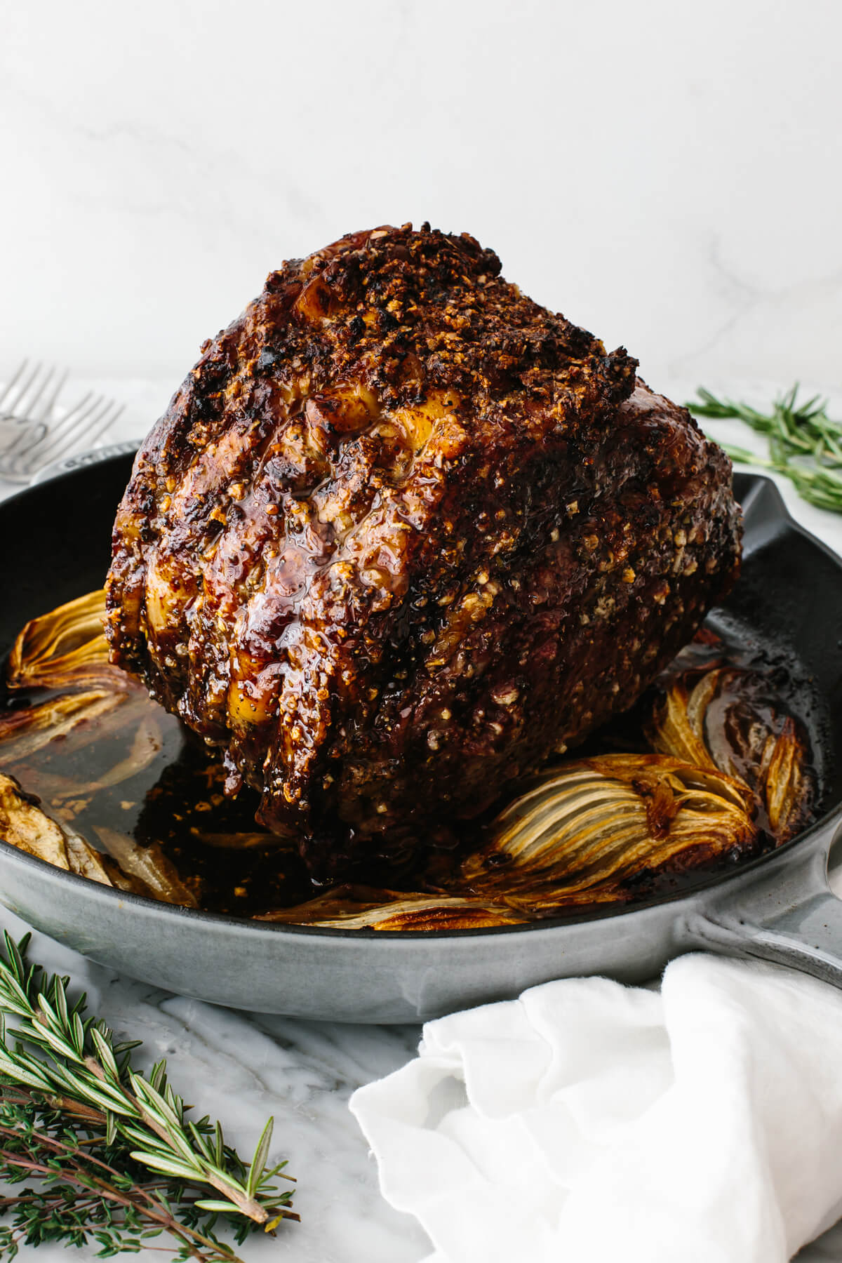 Cooked prime rib standing in pan.