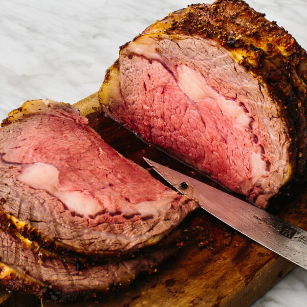 Prime rib on a cutting board.