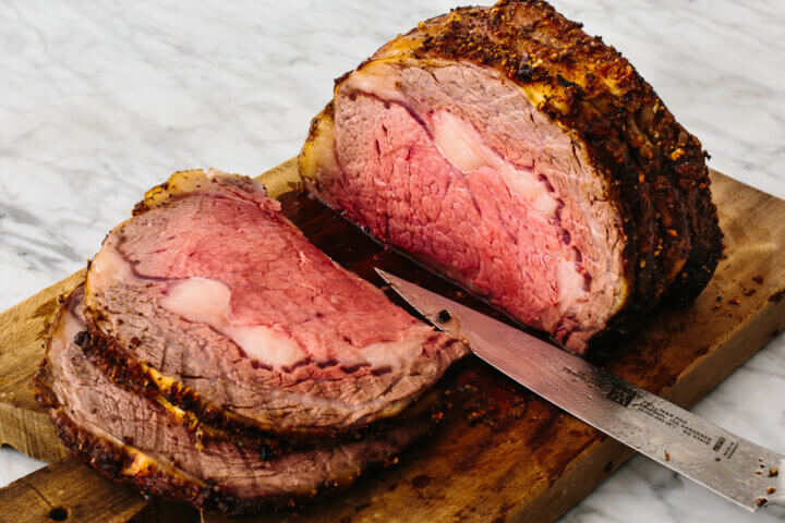 Prime rib on a cutting board.