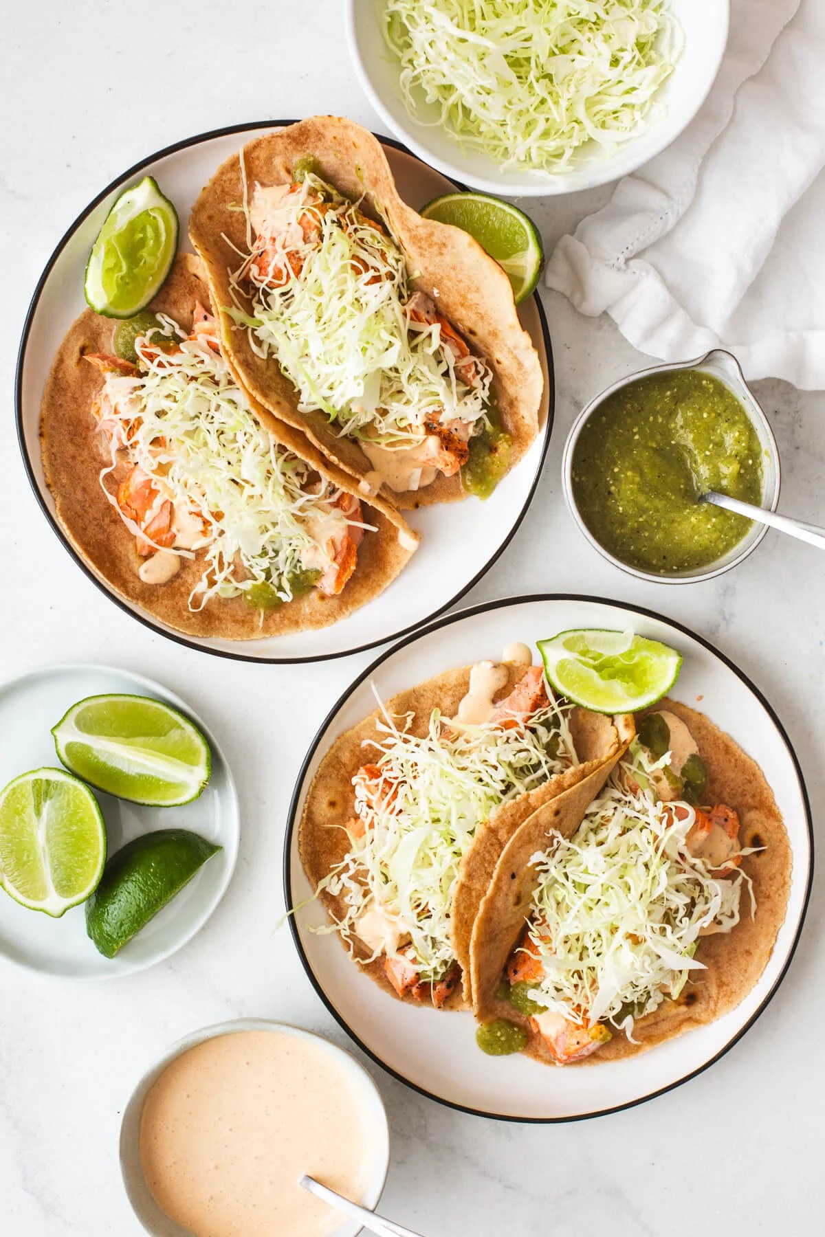 Grilled salmon tacos on two plates