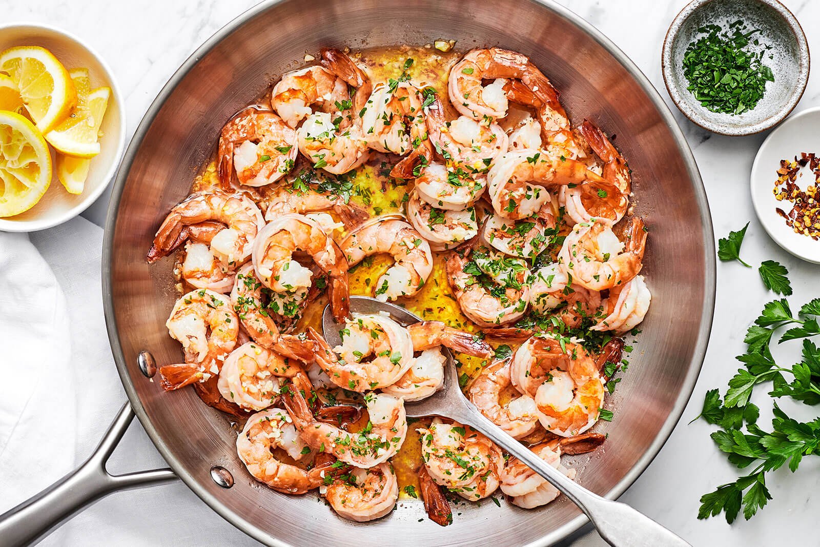 A silver pan of shrimp scampi