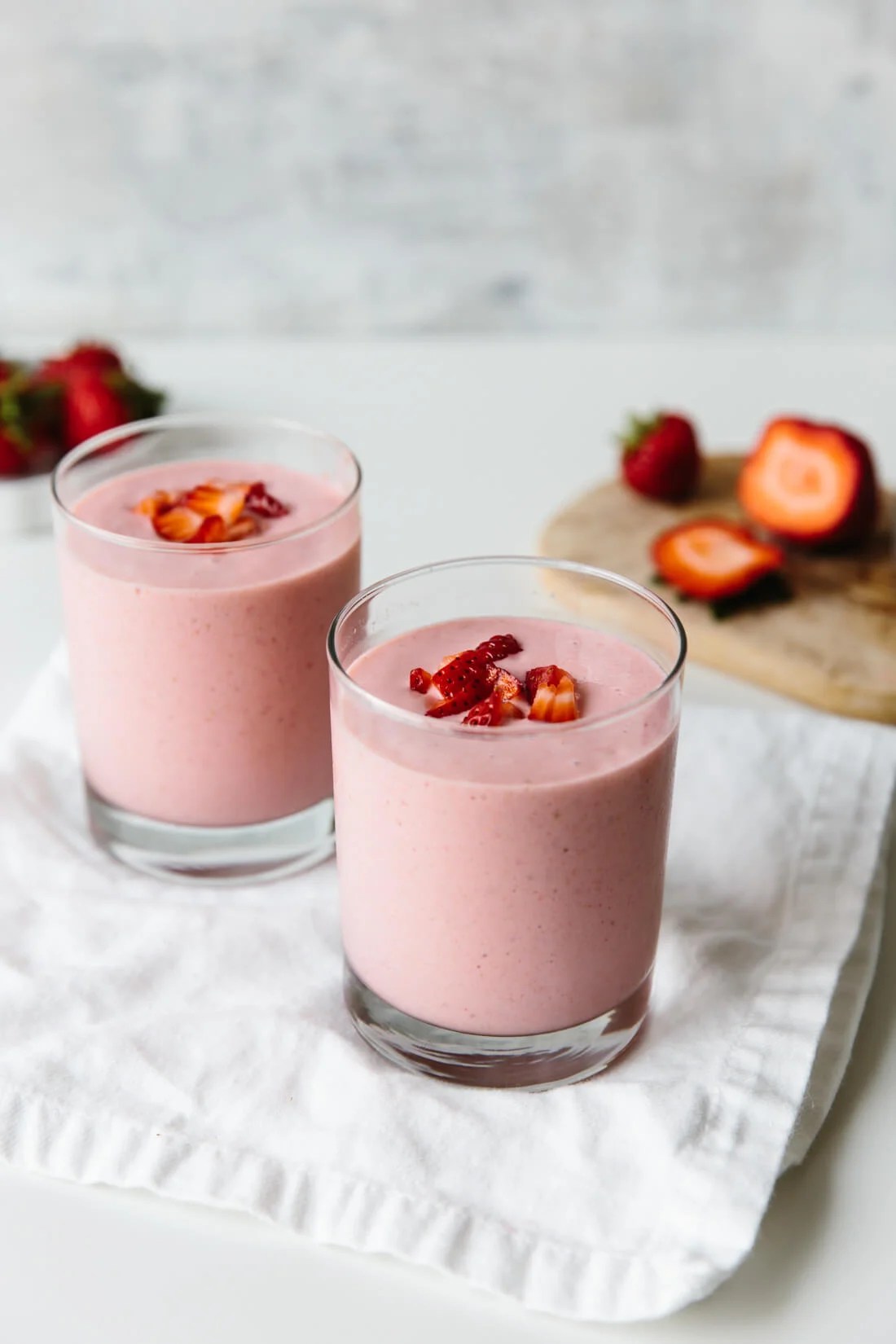 Two glasses of strawberry banana smoothie. 