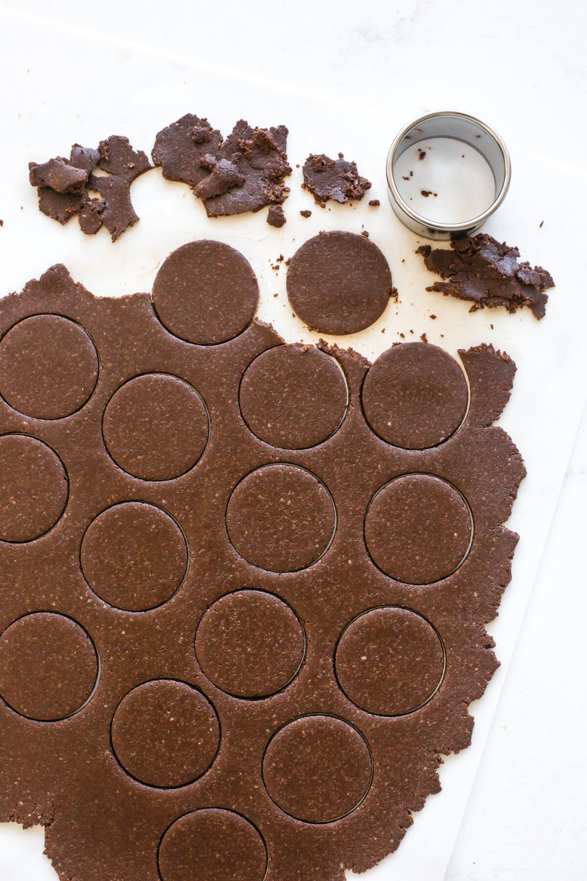 Cutting cookies with a cookie cutter.