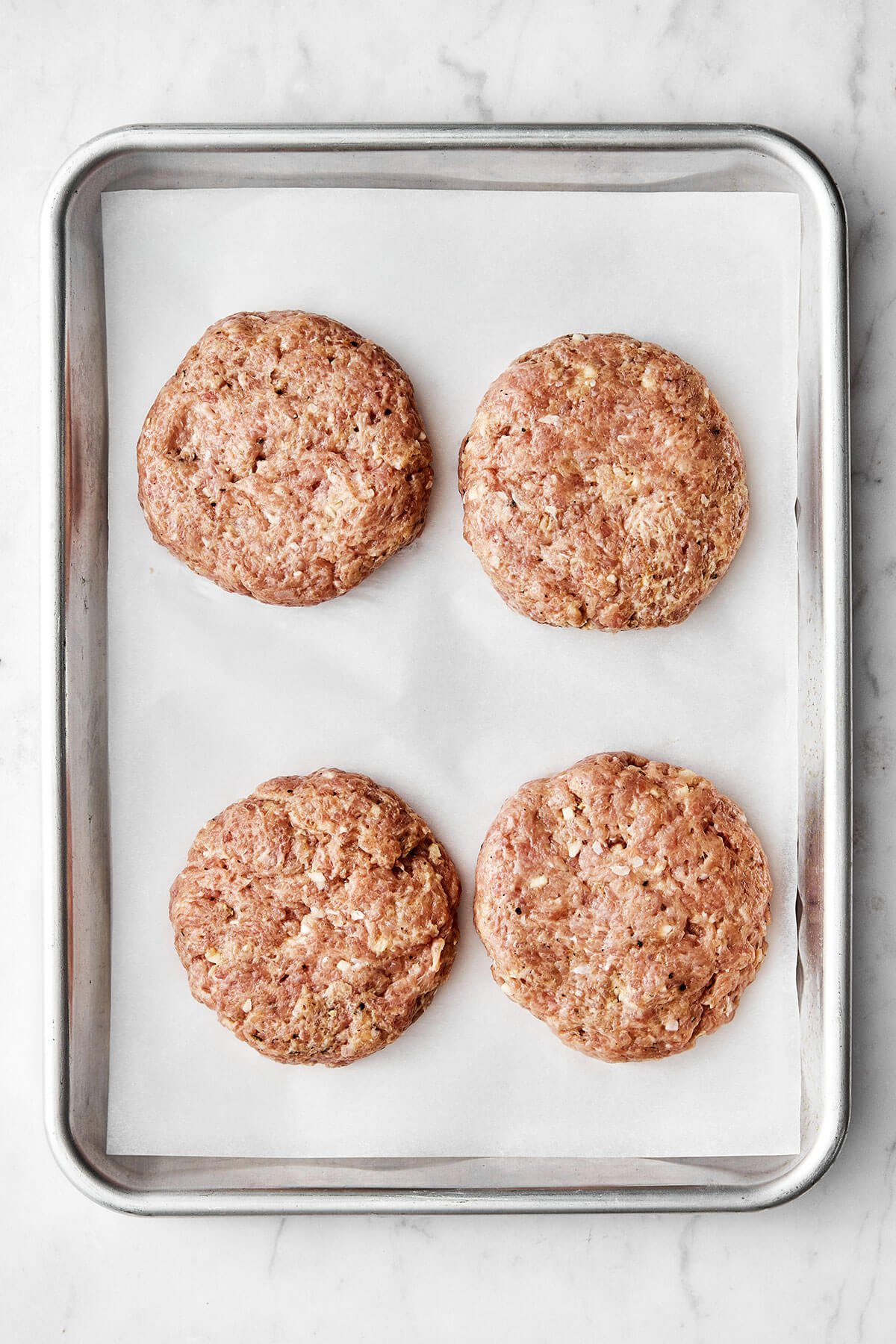 Turkey burger patties on a sheet pan