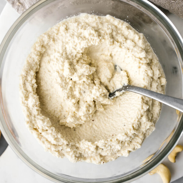 A glass bowl of vegan cashew ricotta cheese