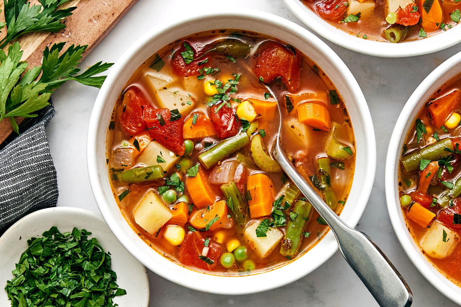 A white bowl of vegetable soup