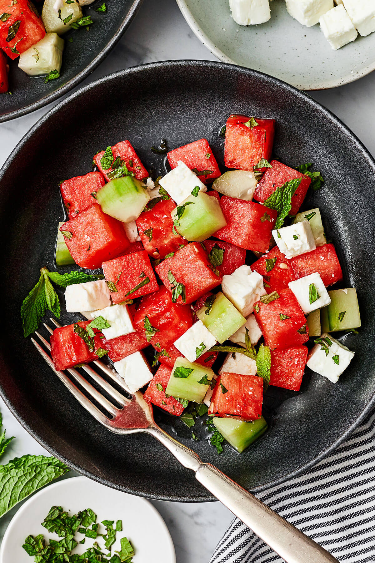 Watermelon salad in a black bowl