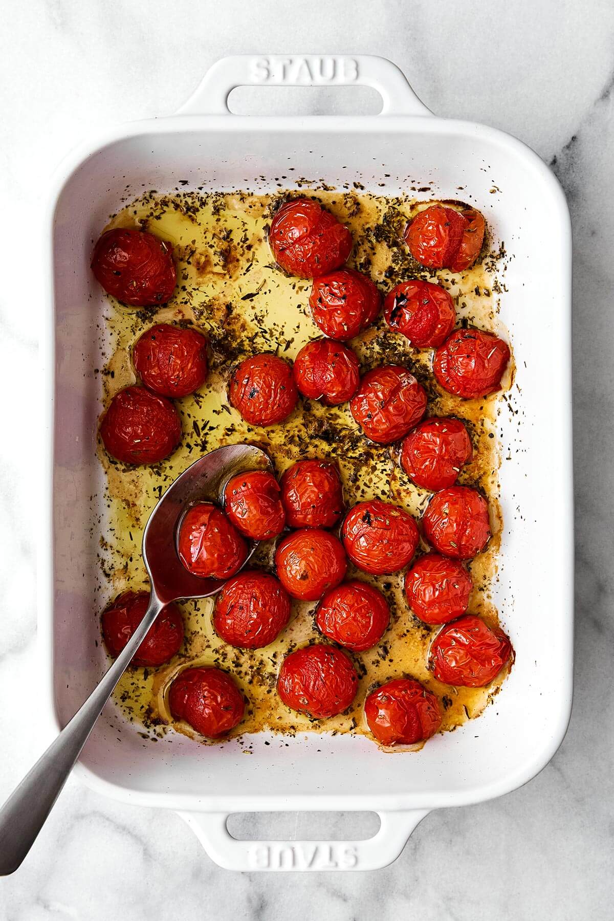 Roasted tomatoes in a baking dish.