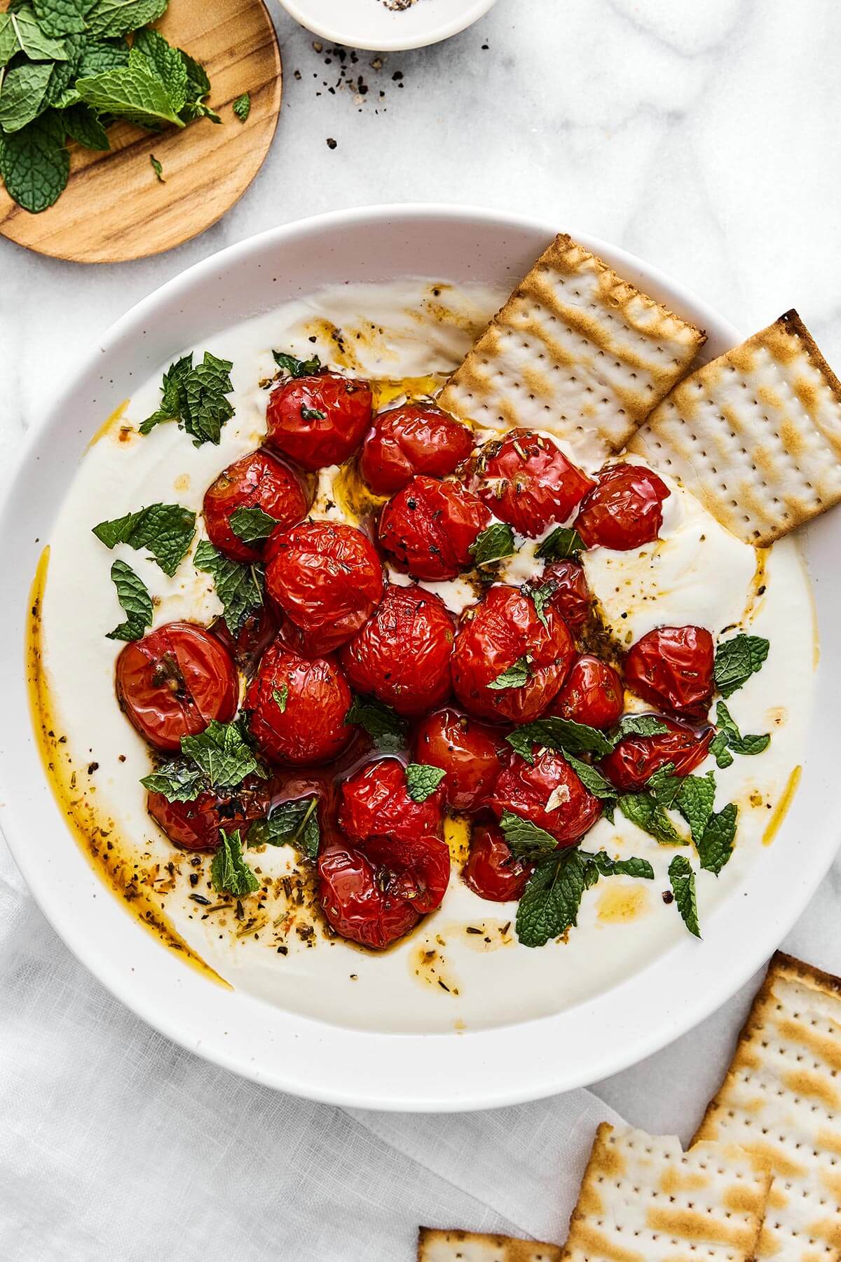 A bowl of whipped feta with roasted tomatoes.