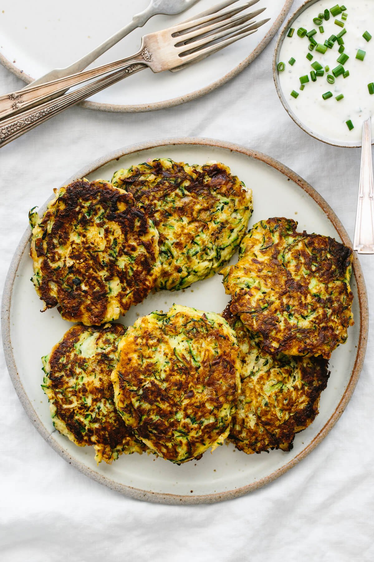 A top down view of a plate of zucchini fritters.