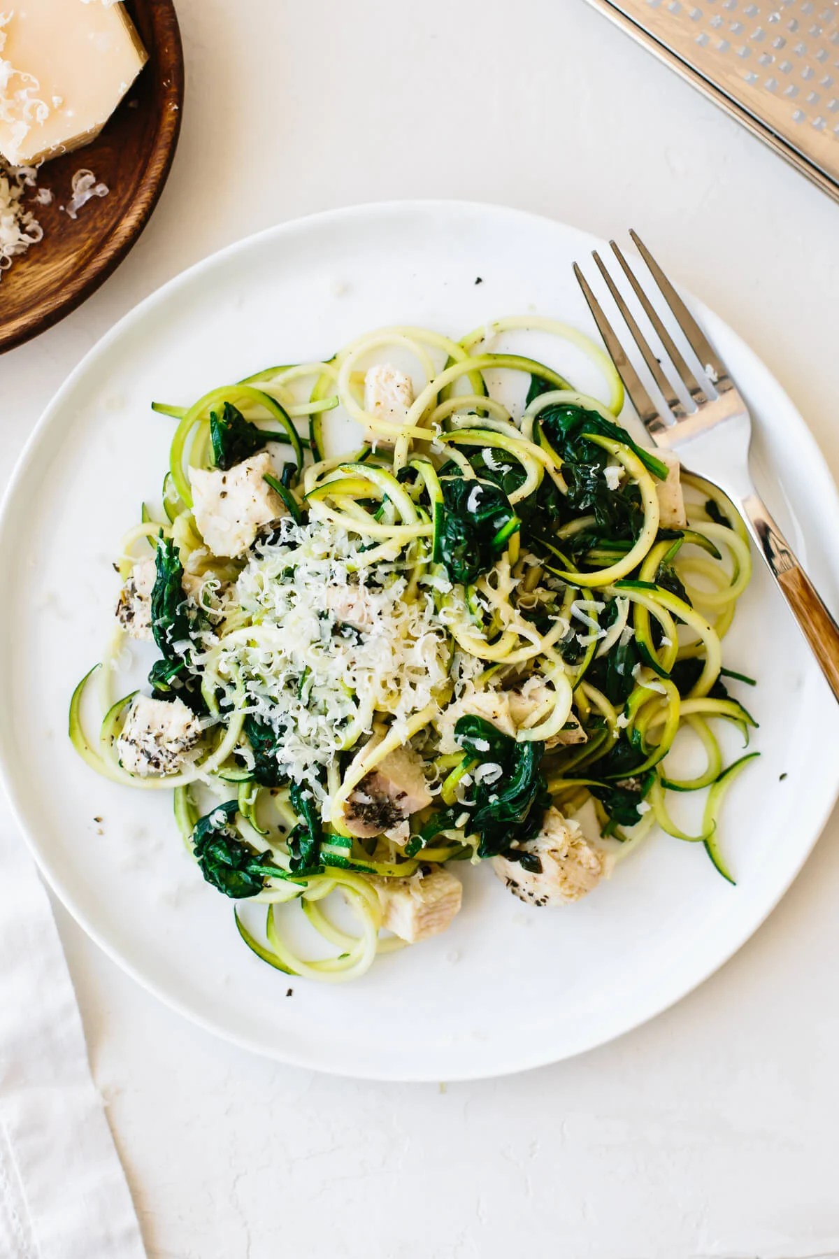 Zucchini noodles with chicken on a plate with fork.