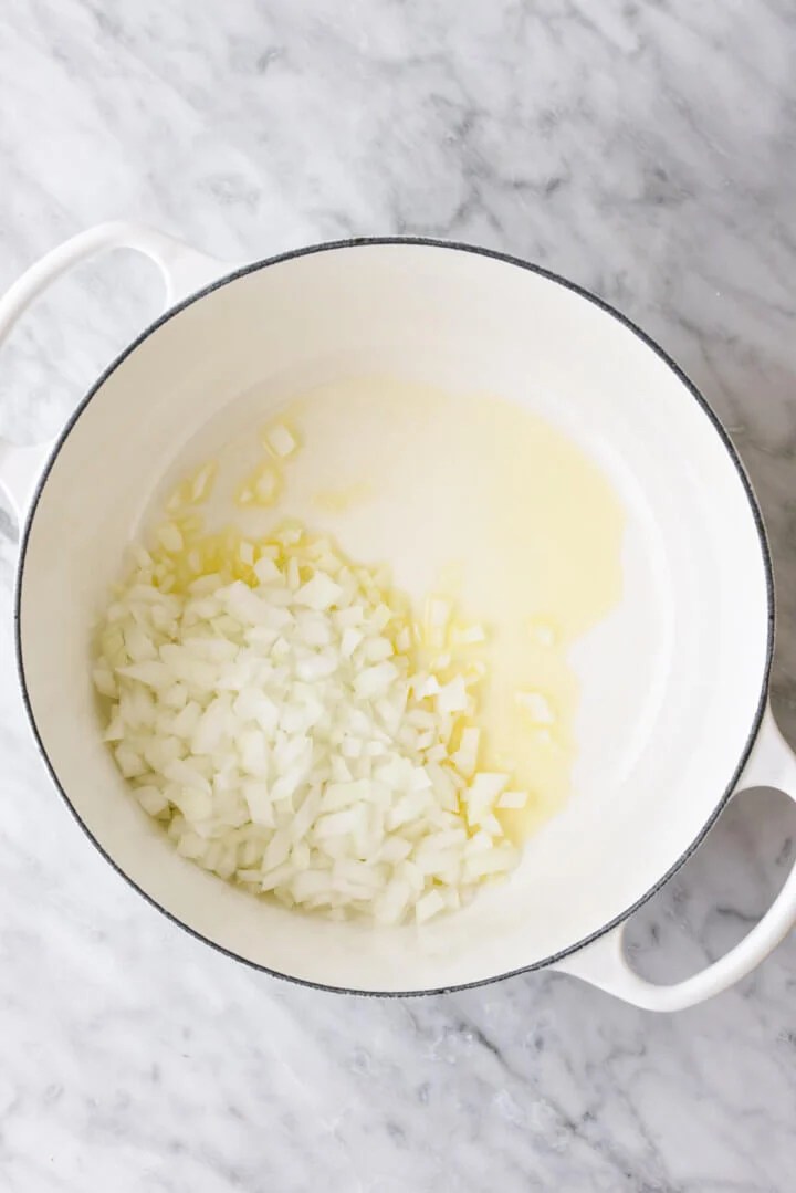 Sauteeting onions in a pot for zucchini soup