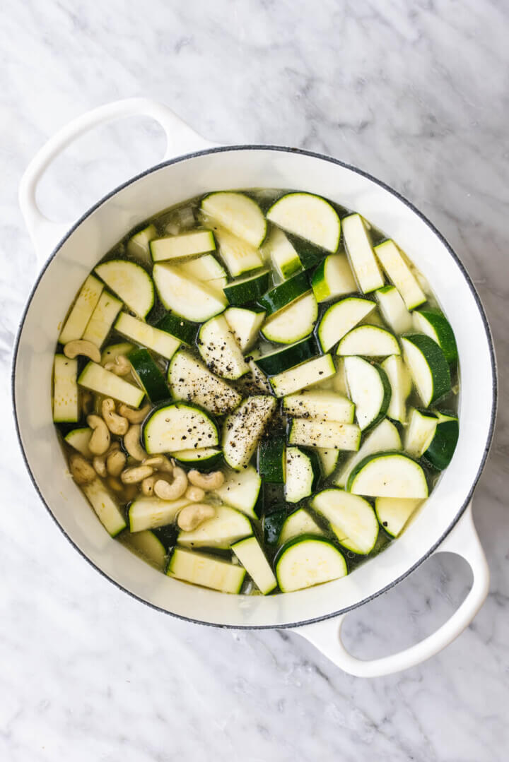 Cooking zucchini in a pot for zucchini soup.